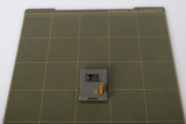 3D printers print plate with 3D printed depth caliper locking block on it