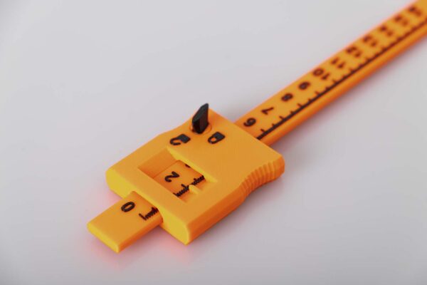 Detail of the 3D printed caliper printed in orange and black