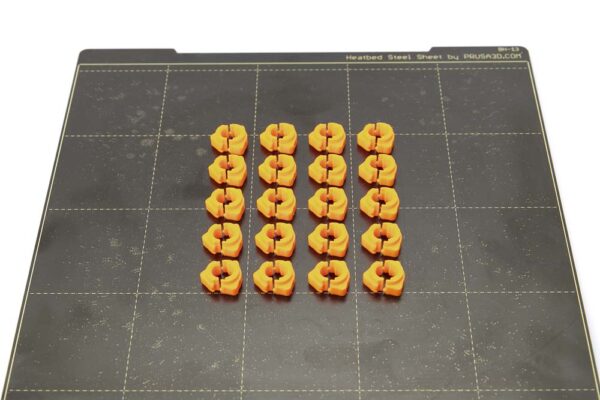 Spring steel print plate Prusa i3 Mk3S with 20 pieces of 3D printed quick-release nuts in orange PETG.