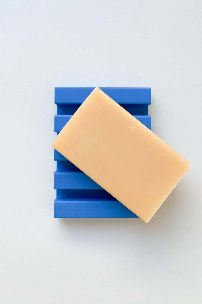 3D printed soap dish, printed in blue filament, showing the rectangular design with a bar of soap placed on it