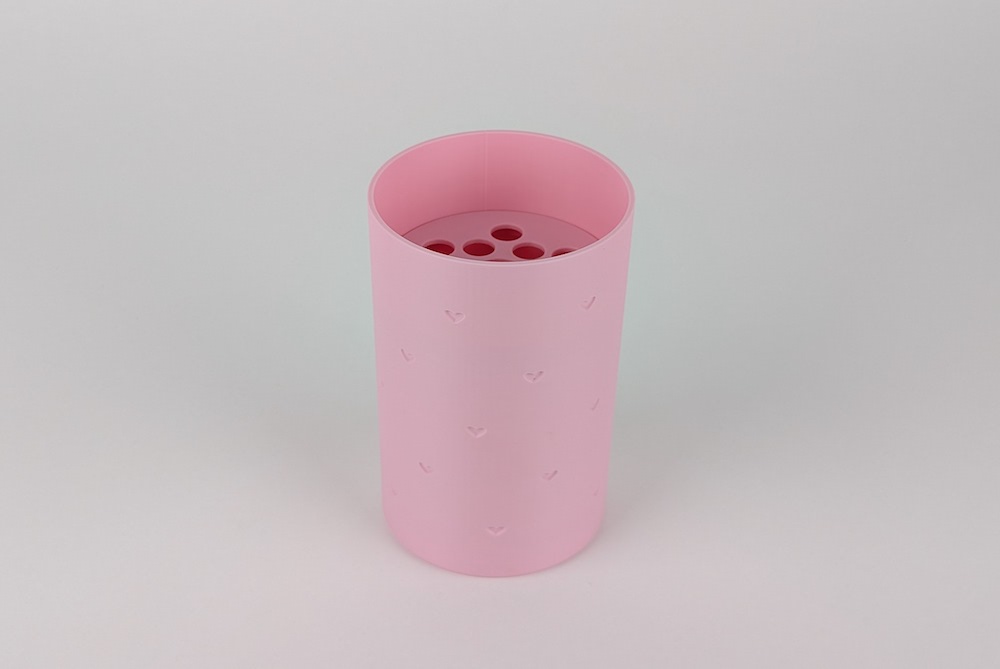 3D printed vase with flower disk, printed in pink filament, showing the design for single color with recessed hearts with the flower disk.
