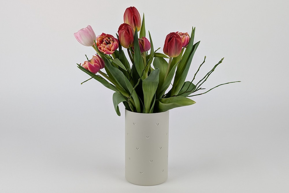Flower vase with recessed hearts, 3D printed in a single color using beige filament.