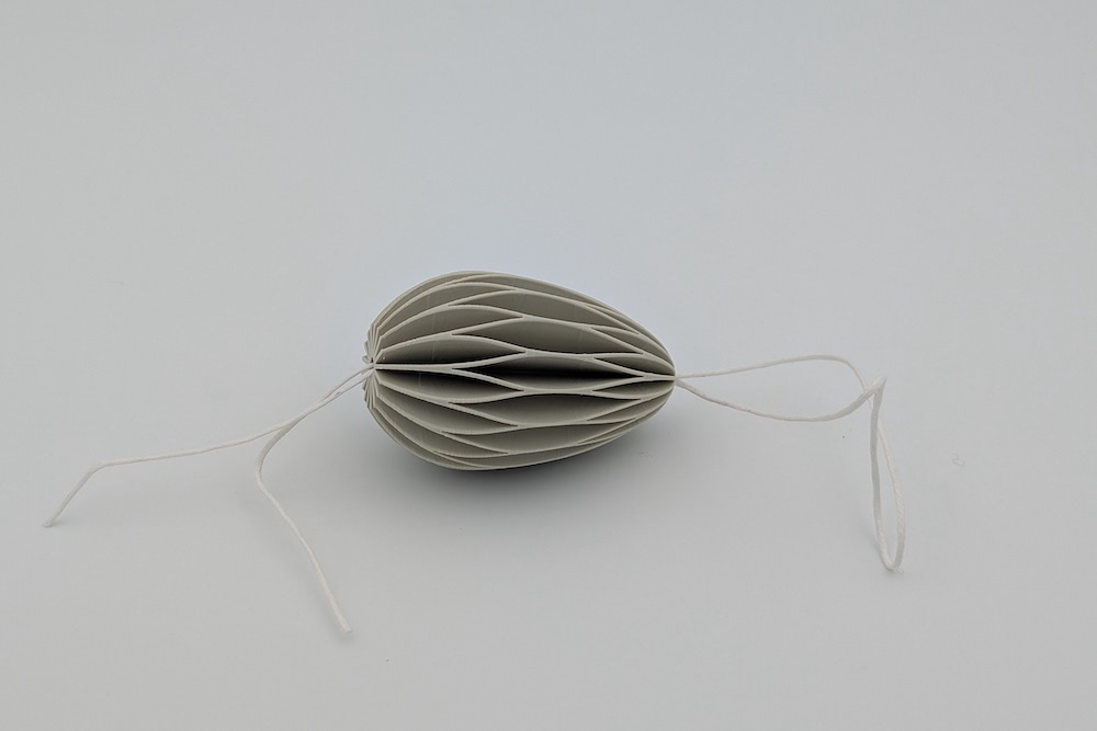 String for threading the Easter eggs and a beige Easter egg