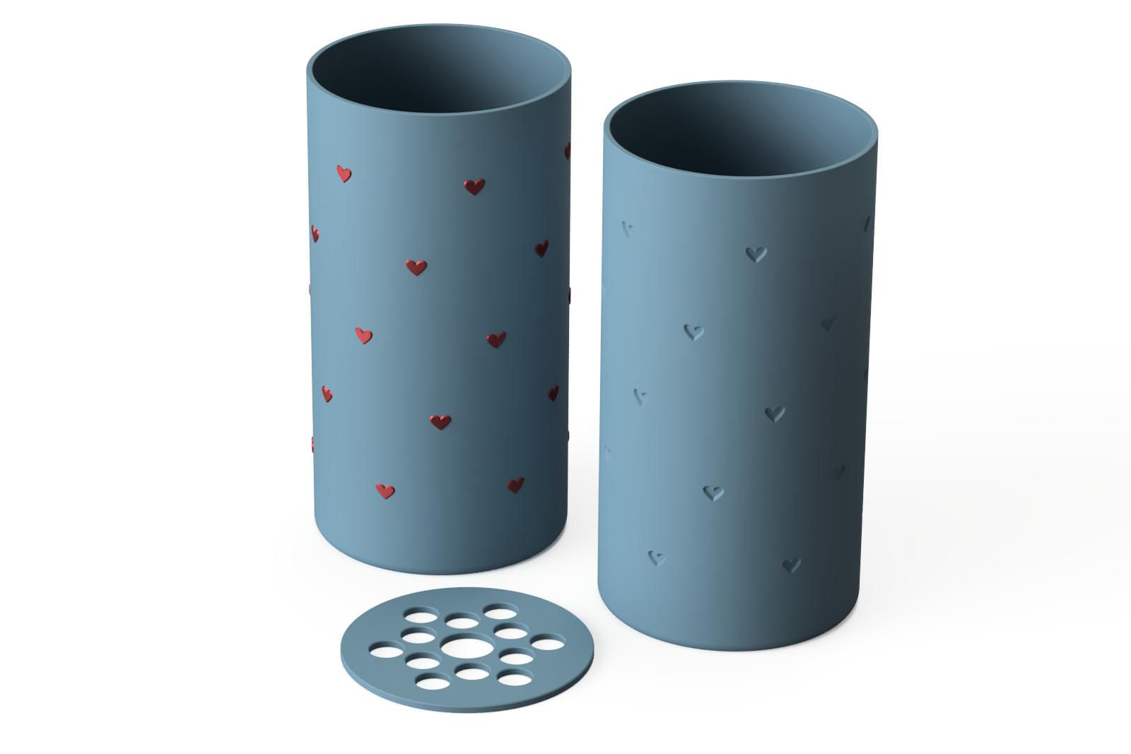 3D print file renderings for the flower vase with small hearts, showing the version with raised hearts in a different color, the version with recessed hearts for single-color 3D printing, and a flower frog insert for the vase.