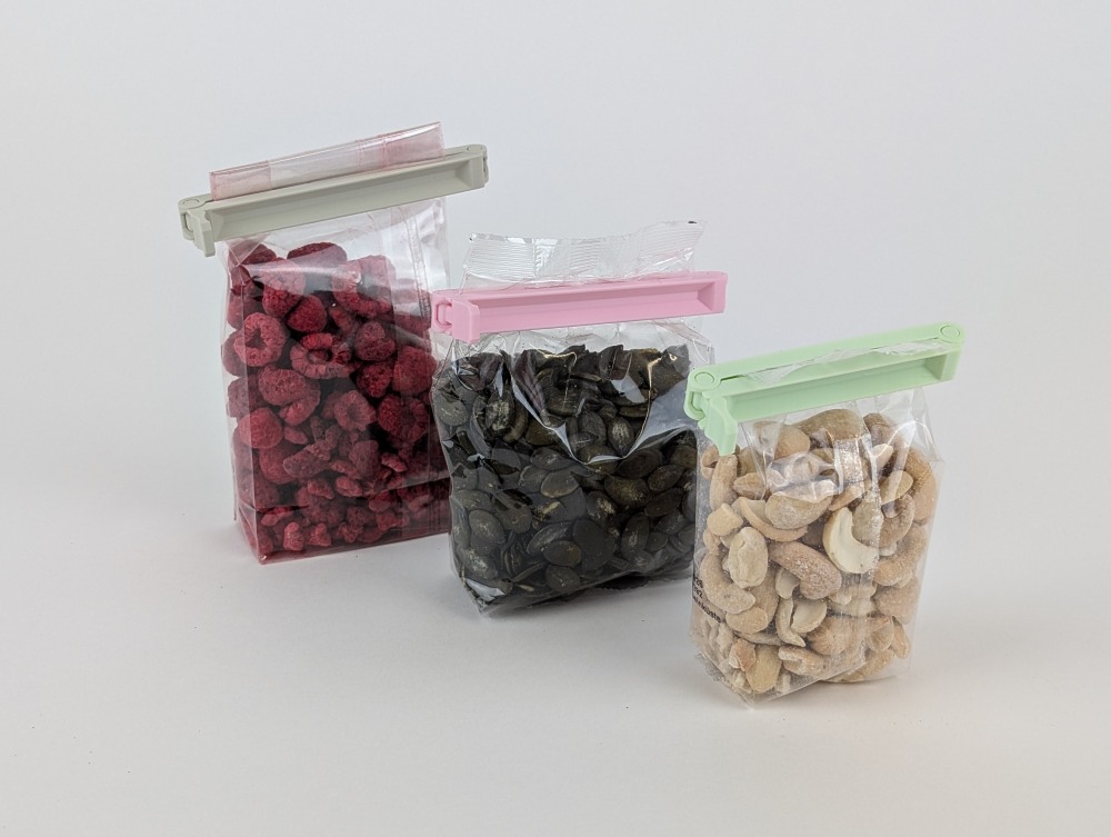 3D printed bag sealing clips in matte Beige, Pink and Mint, closing three different packages
